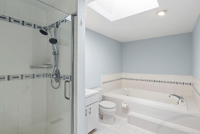 full bathroom featuring a garden tub, a skylight, a stall shower, vanity, and toilet