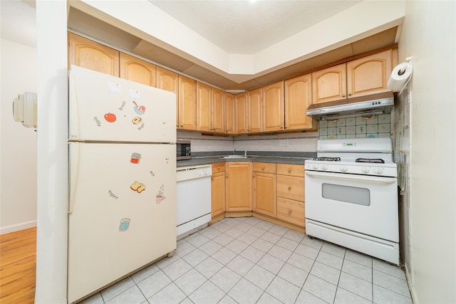 140-44 34th Ave Unit 4C, Flushing, NY 11354 - kitchen featuring white appliances, under cabinet range hood, dark countertops, and light brown cabinetry