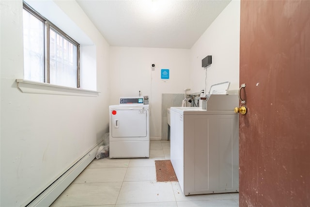 140-44 34th Ave Unit 4C, Flushing, NY 11354 - community laundry room featuring baseboard heating, washer and clothes dryer, and light tile patterned flooring