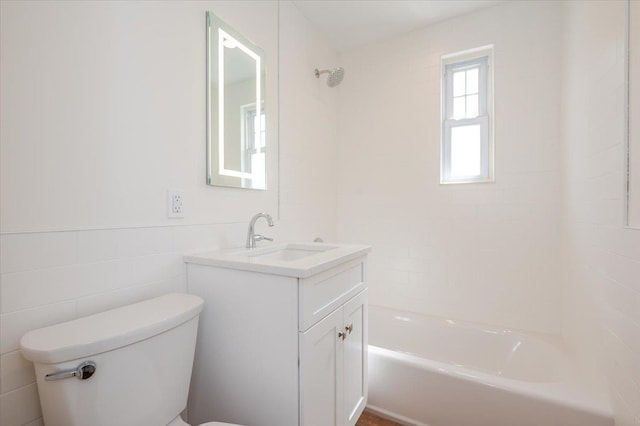 full bathroom with toilet, shower / bath combination, vanity, and tile walls