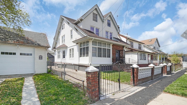 9920 196th St, Hollis, NY 11423 - view of front of house with roof with shingles, a fenced front yard, a gate, a garage, and an outdoor structure