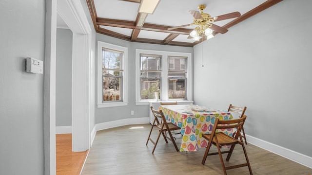 9920 196th St, Hollis, NY 11423 - dining area featuring light wood-style floors, baseboards, ceiling fan, and coffered ceiling