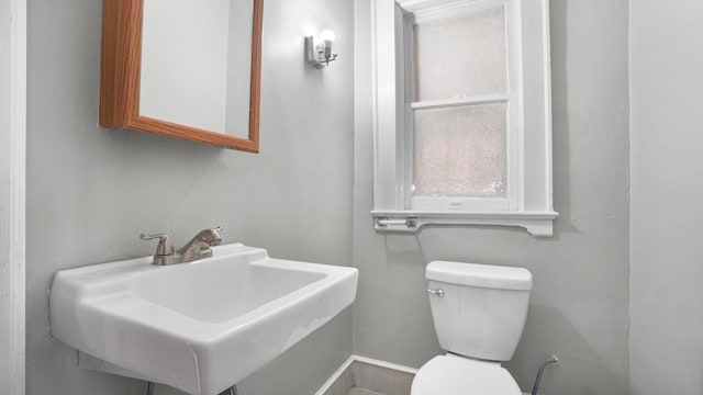 9920 196th St, Hollis, NY 11423 - half bath with baseboards, a sink, and toilet