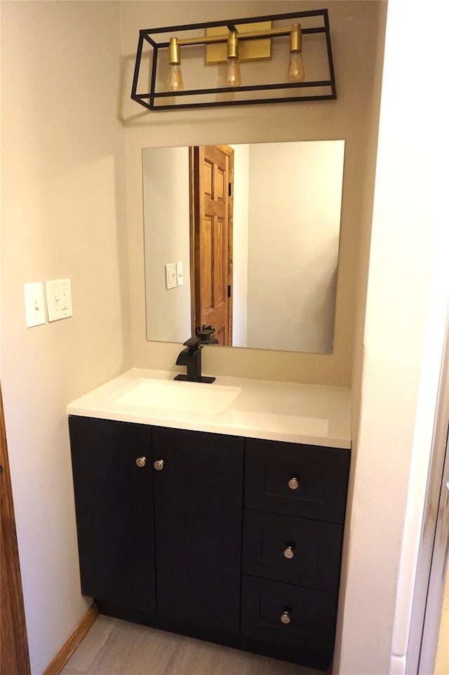 bathroom with baseboards and vanity