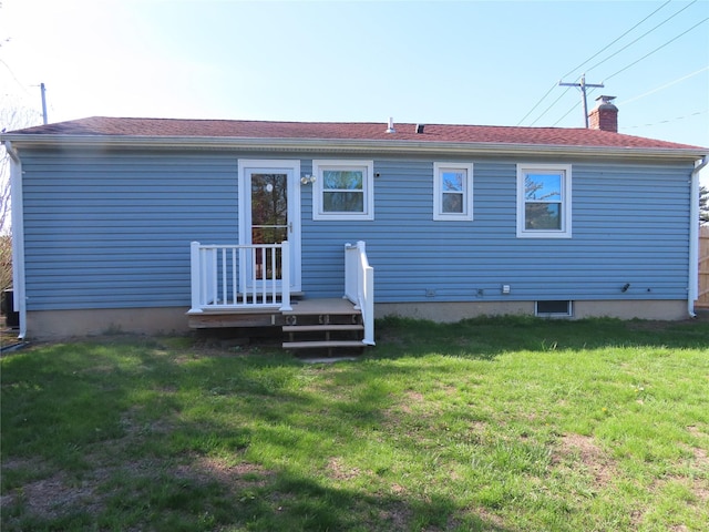 565 18th St, West Babylon, NY 11704 - back of house featuring a lawn and a chimney