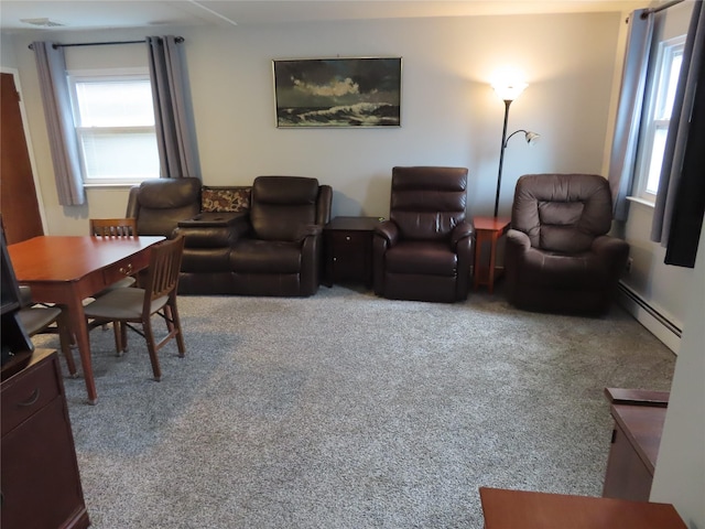565 18th St, West Babylon, NY 11704 - living area with carpet floors and a baseboard radiator
