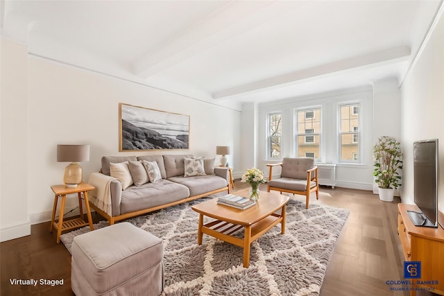 living room with baseboards and beam ceiling