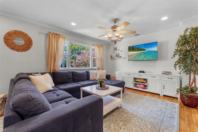 living area with a ceiling fan, recessed lighting, ornamental molding, and light wood finished floors