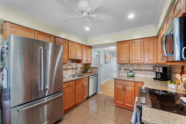 kitchen with ceiling fan, light tile patterned floors, a sink, appliances with stainless steel finishes, and backsplash