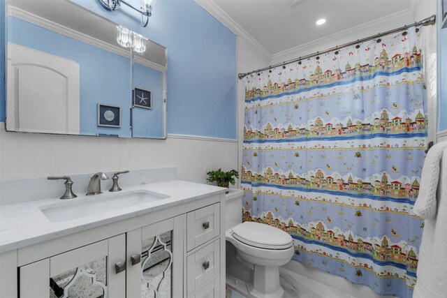 bathroom featuring wainscoting, vanity, toilet, a shower with shower curtain, and ornamental molding