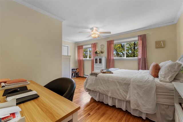 bedroom featuring a ceiling fan, ornamental molding, and light wood finished floors