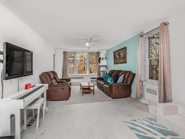 living room featuring a healthy amount of sunlight, radiator, and marble finish floor