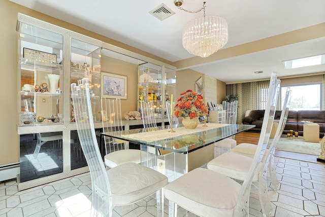 dining space featuring an inviting chandelier, visible vents, and baseboard heating