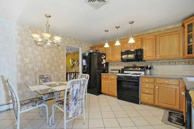 kitchen featuring visible vents, brown cabinetry, black appliances, light tile patterned floors, and a notable chandelier