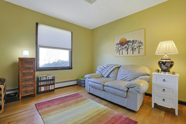 living room featuring baseboard heating and wood finished floors