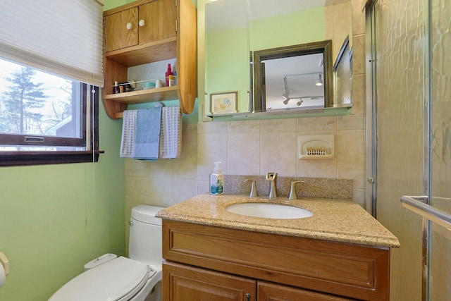 bathroom featuring vanity, backsplash, toilet, and tile walls