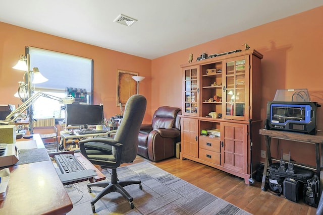office featuring wood finished floors and visible vents