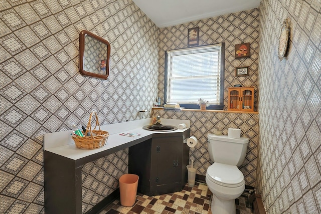 half bath featuring toilet and vanity