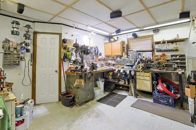 misc room featuring tile patterned floors and a workshop area