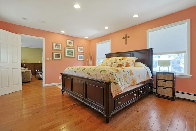 bedroom featuring light wood-type flooring, recessed lighting, and multiple windows