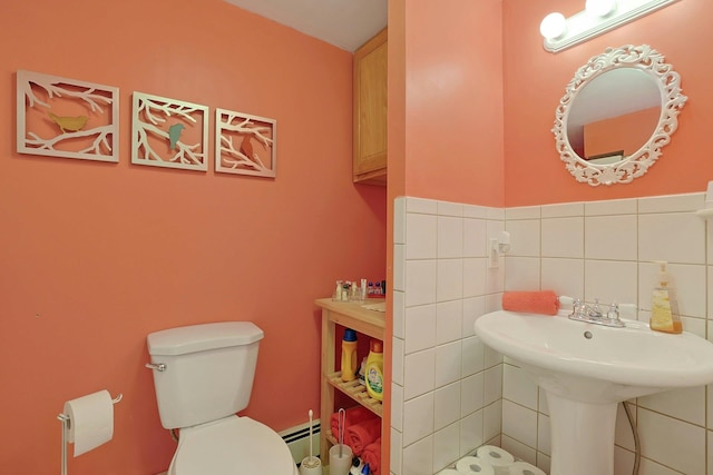 bathroom featuring tile walls, a baseboard radiator, and toilet