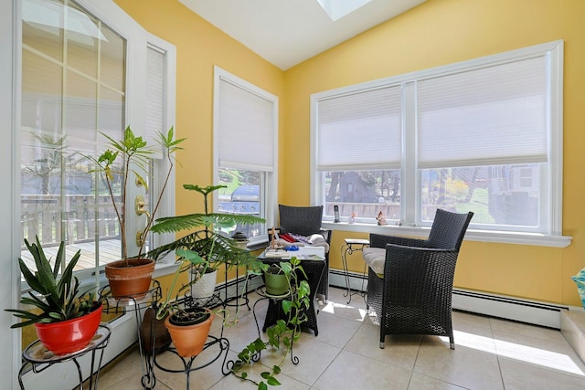 interior space with lofted ceiling with skylight and baseboard heating