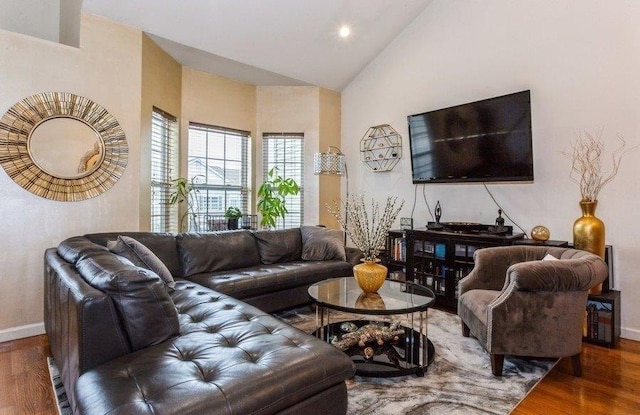living room with high vaulted ceiling, baseboards, wood finished floors, and recessed lighting