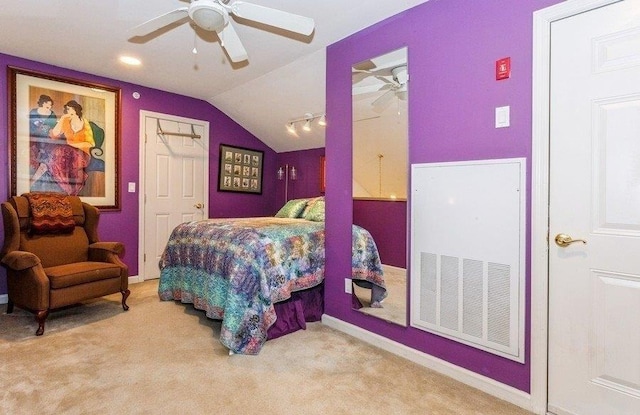 carpeted bedroom featuring lofted ceiling, visible vents, and ceiling fan
