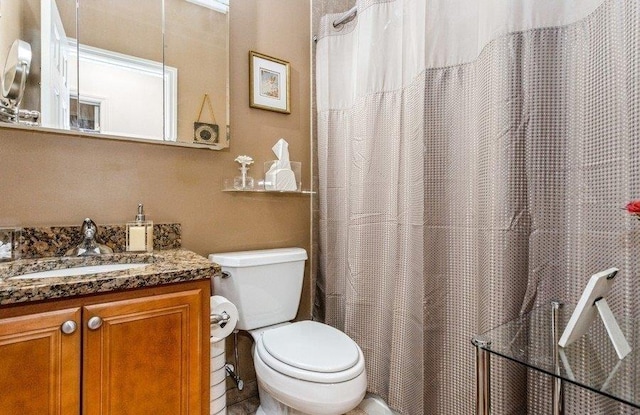 full bath with toilet and vanity