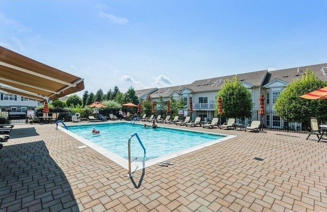 pool featuring a patio area and fence