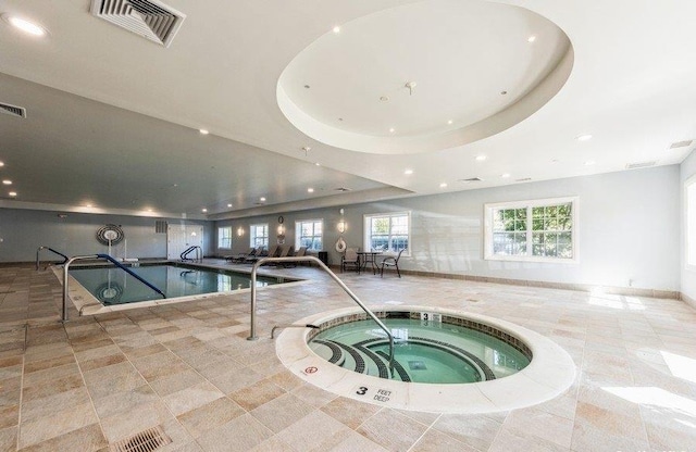 community pool featuring an indoor in ground hot tub