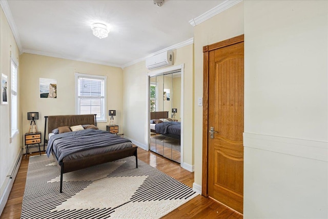 21-09 48th St, Astoria, NY 11105 - bedroom featuring baseboards, ornamental molding, a wall unit AC, and light wood finished floors