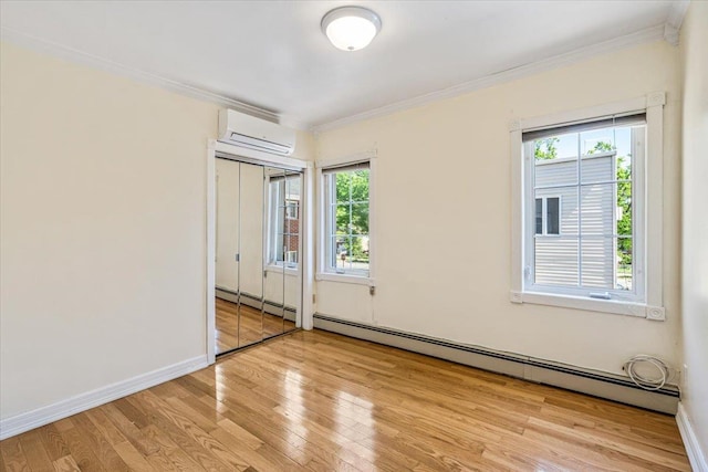 21-09 48th St, Astoria, NY 11105 - empty room featuring an AC wall unit, ornamental molding, wood finished floors, and a wealth of natural light