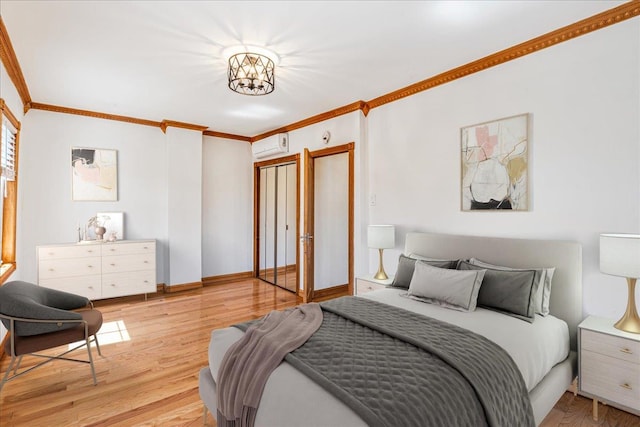 21-09 48th St, Astoria, NY 11105 - bedroom with light wood-style floors, a chandelier, baseboards, a wall unit AC, and ornamental molding