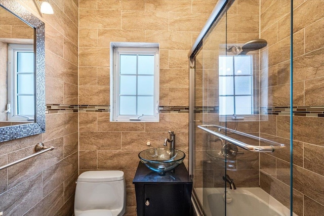 21-09 48th St, Astoria, NY 11105 - full bathroom with toilet, tile walls, bath / shower combo with glass door, and vanity