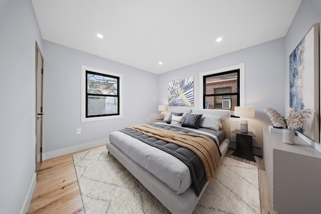bedroom with light wood finished floors, baseboards, and recessed lighting