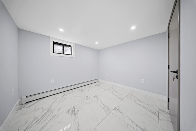 below grade area with a baseboard radiator, marble finish floor, and recessed lighting