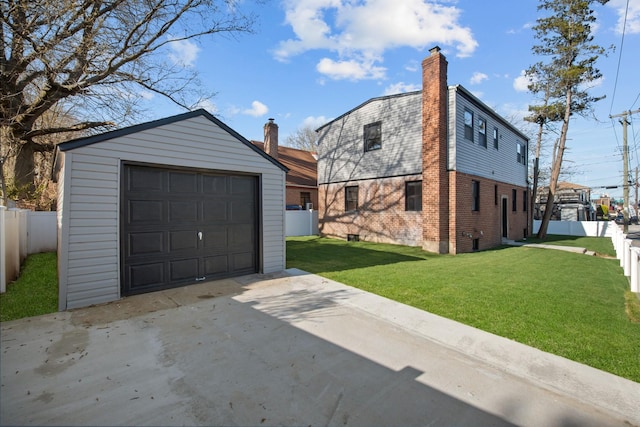 detached garage with driveway and fence