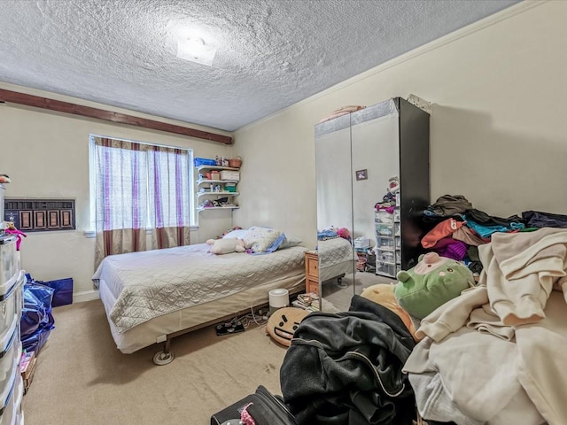 bedroom with carpet flooring and a textured ceiling