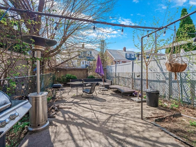 view of patio with an outdoor living space, a fenced backyard, and a grill