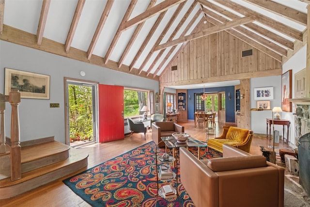 1391 Hunterbrook Rd, Yorktown Heights, NY 10598 - living room with high vaulted ceiling, wood finished floors, beam ceiling, stairway, and a fireplace