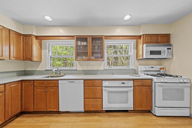 1391 Hunterbrook Rd, Yorktown Heights, NY 10598 - kitchen featuring white appliances, a sink, light wood-type flooring, brown cabinets, and light countertops