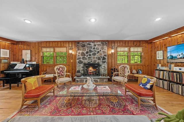 1391 Hunterbrook Rd, Yorktown Heights, NY 10598 - living room featuring plenty of natural light, wooden walls, wood finished floors, a stone fireplace, and crown molding