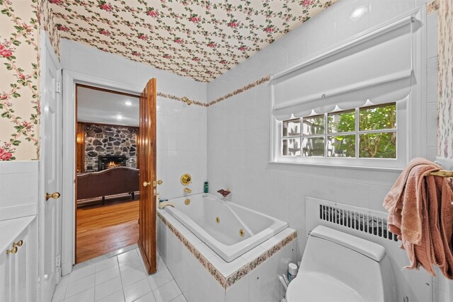 1391 Hunterbrook Rd, Yorktown Heights, NY 10598 - bathroom featuring a whirlpool tub, a stone fireplace, toilet, and tile patterned flooring