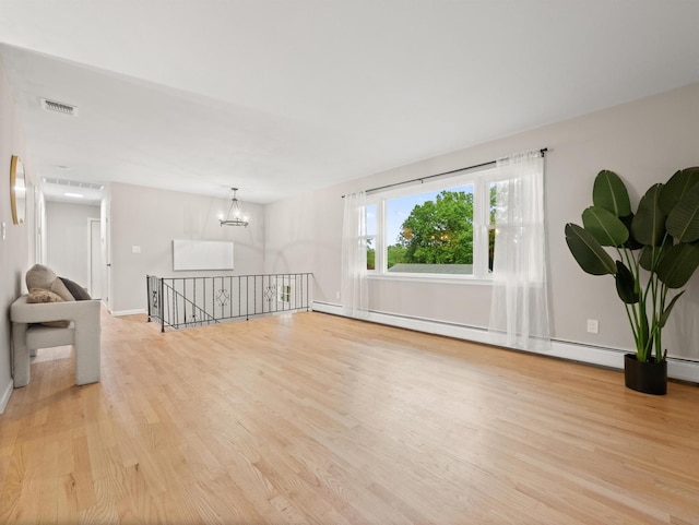 31 Pennsylvania Ave, Valley Cottage, NY 10989 - unfurnished room with light wood-style floors, a chandelier, a baseboard radiator, and baseboards