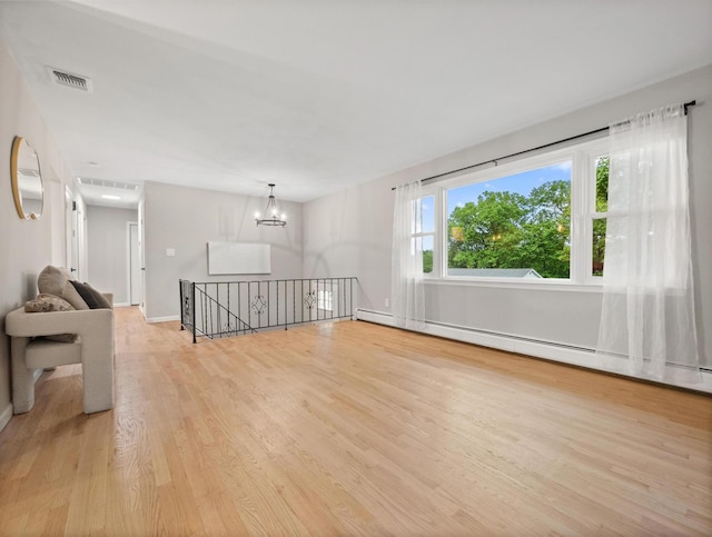 31 Pennsylvania Ave, Valley Cottage, NY 10989 - empty room featuring light wood-style floors, a chandelier, baseboard heating, and baseboards