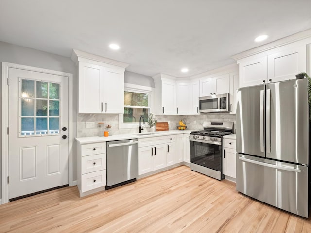 31 Pennsylvania Ave, Valley Cottage, NY 10989 - kitchen featuring stainless steel appliances, a sink, light countertops, white cabinetry, and backsplash