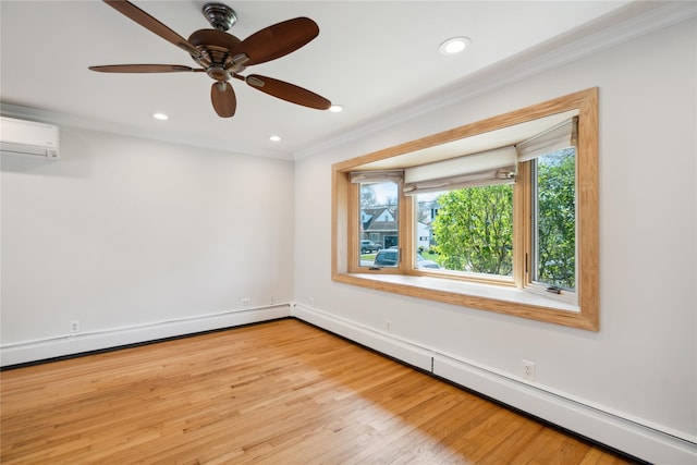 spare room featuring light wood finished floors, an AC wall unit, crown molding, and baseboard heating