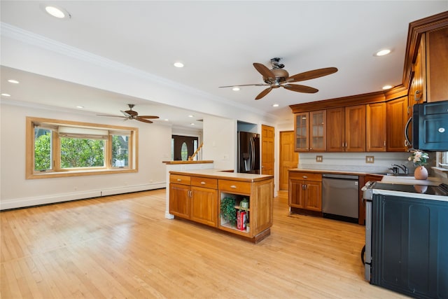 kitchen featuring stainless steel appliances, a ceiling fan, brown cabinets, and ornamental molding