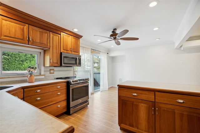 kitchen featuring brown cabinets, stainless steel appliances, and light countertops